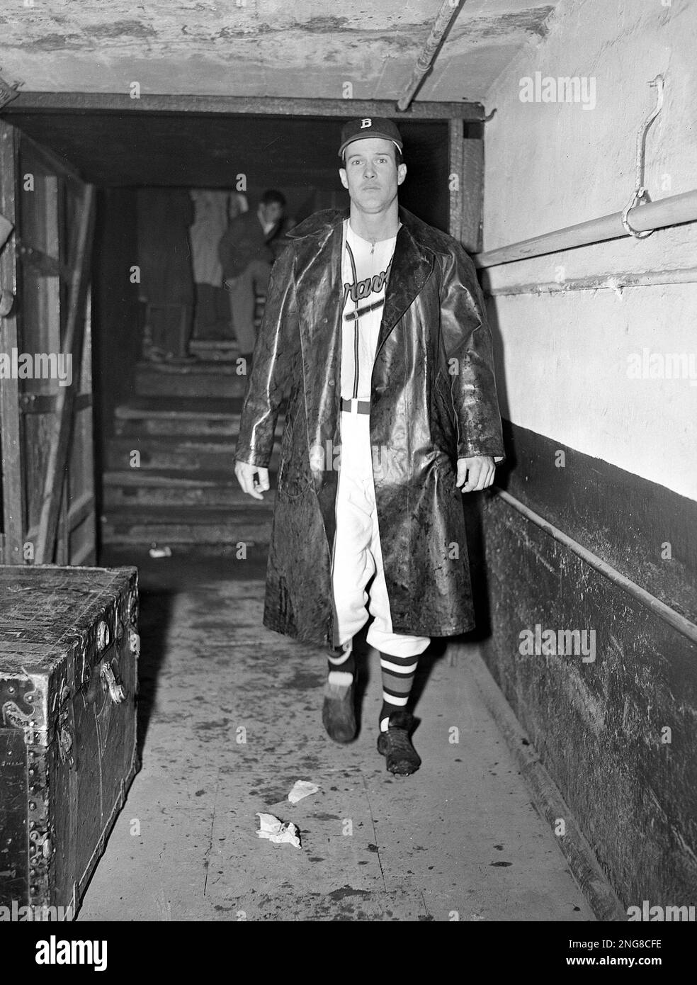 Boston Braves' Connie Ryan walks to the shower after being ejected from the game by umpire George Barr, for wearing a raincoat in the on deck circle, in protest against playing in the rain, Sept. 29, 1949, in Boston. (AP Photo/Abe Fox) Stock Photo