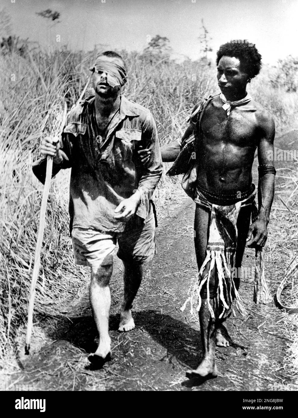A Papua New Guinea native helps an Australian infantryman who was