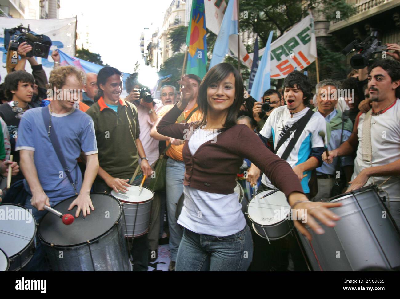 Evangelina Carrozo, an Argentine beauty queen who disrupted a presidential summit in Vienna last week with a bikini-baring protest against Uruguay's pulp mill plants, dances while demonstrators beat drums outside Finland's Embassy in Buenos Aires, Wednesday, May 17, 2006, as they staged a protest in Buenos Aires asking to stop the costruction of the two pulp mills in Fray Bentos, Uruguay, by the Finnish firm Botnia and Spain's Ence. (AP Photo/Natacha Pisarenko) Stock Photo