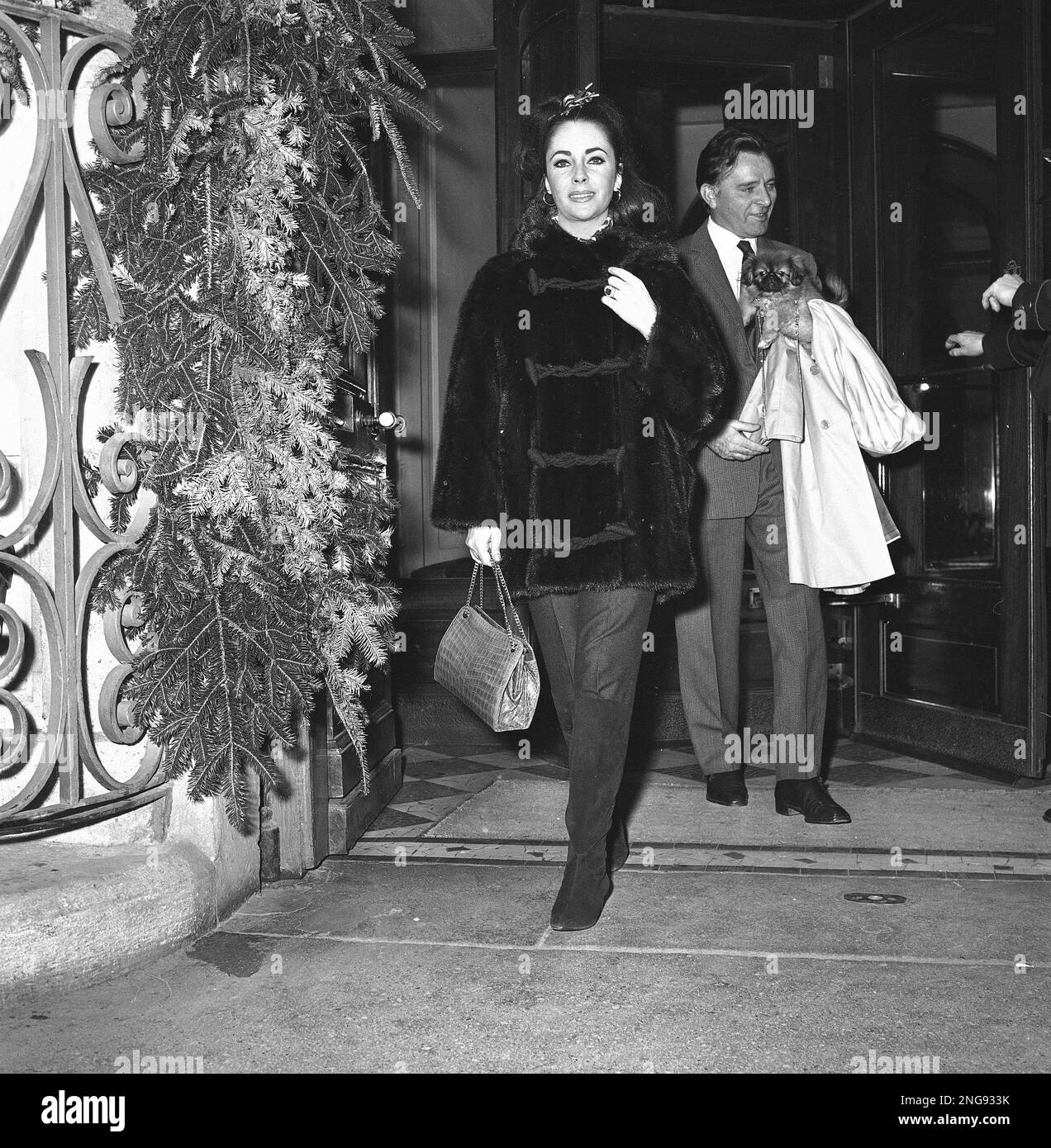 Actress Elizabeth Taylor and her husband, actor Richard Burton leave