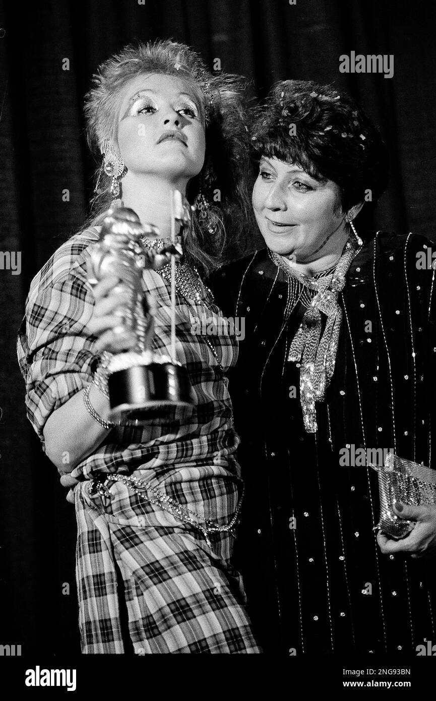 Singer Cyndi Lauper poses with her mother Catrine Dominique while holding the MTV Video Music