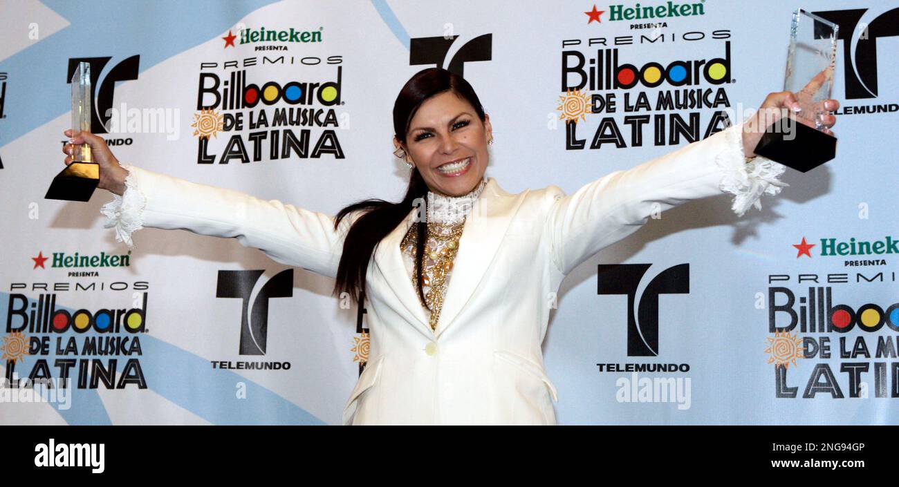 Olga Tanon poses for photos after winning awards at the Latin Billboard