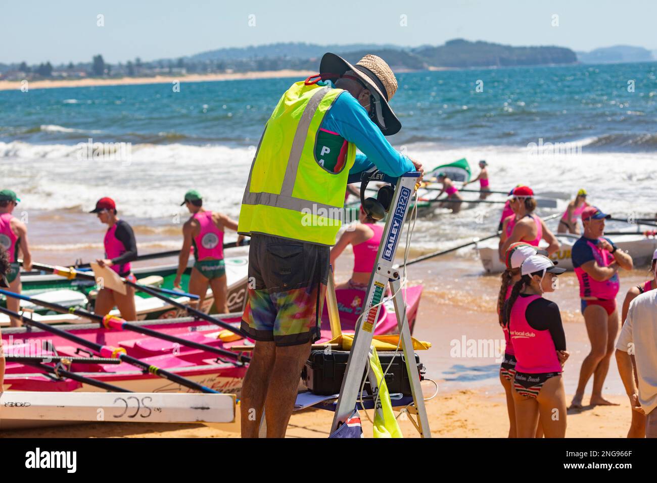 Australian surfboat racing carnival in 2023 at Collaroy beach in Sydney Australia, race Marshall and female crew from Avalon Beach Stock Photo