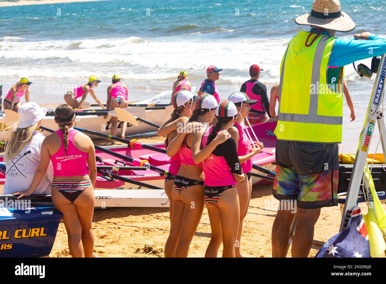 Australian surfboat racing carnival in 2023 at Collaroy beach in Sydney Australia, race Marshall and female crew from Avalon Beach Stock Photo