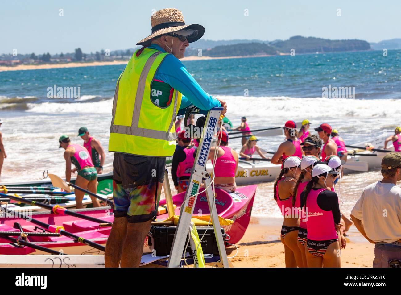 Australian surfboat racing carnival in 2023 at Collaroy beach in Sydney Australia, race Marshall on step ladder oversees racing Stock Photo
