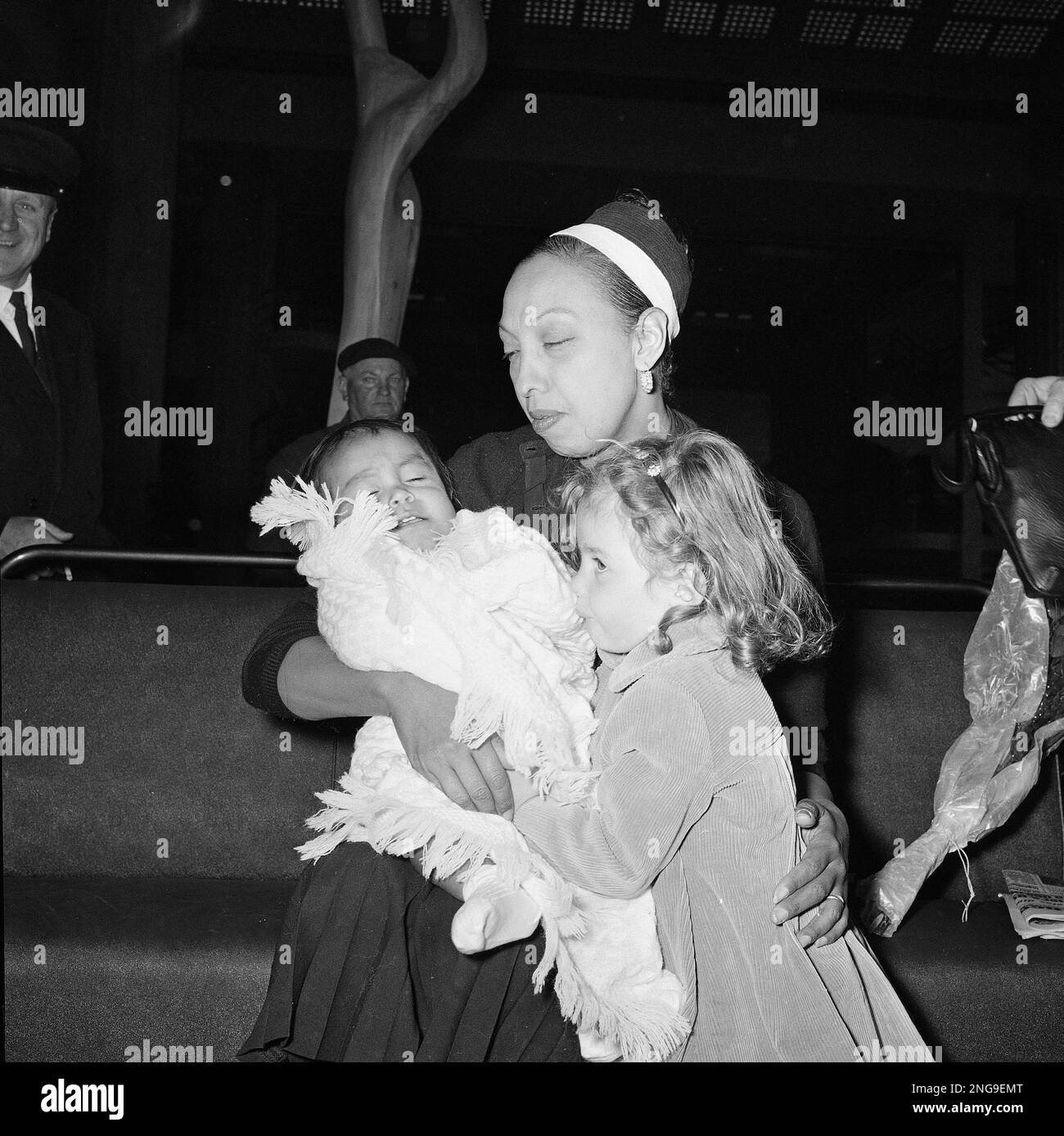 Entertainer Josephine Baker holds in her arms her tenth adopted child