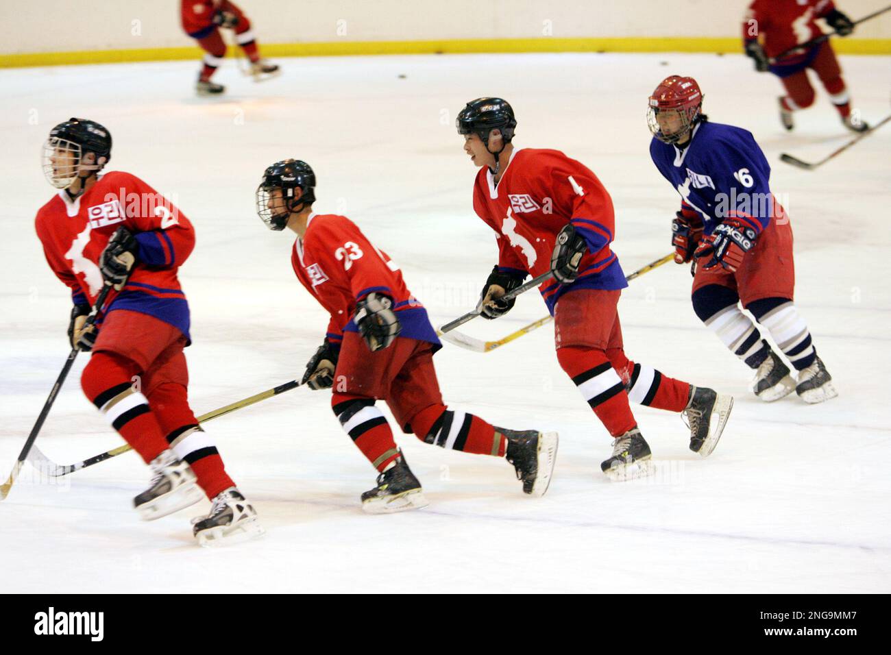 North Korean, red uniform, and South Korean ice hockey players skate