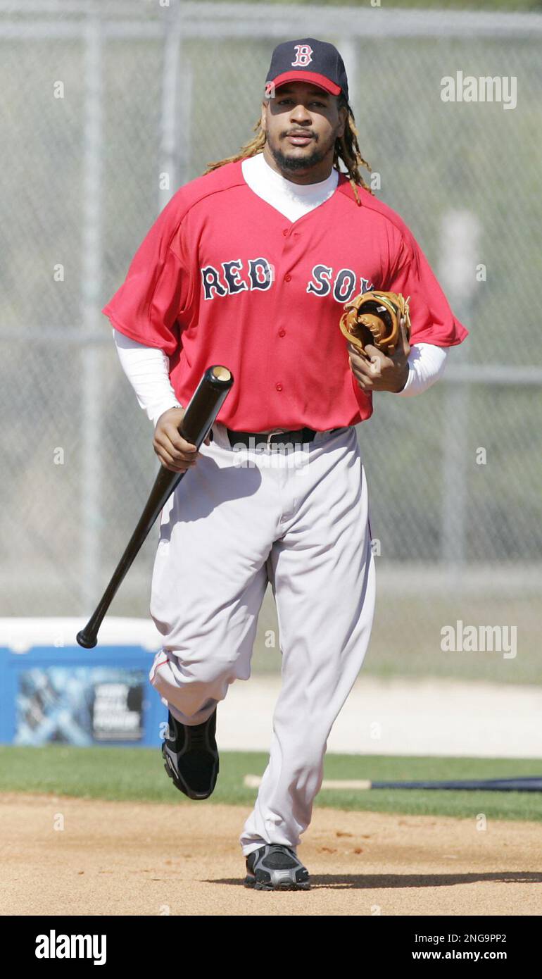 Boston Red Sox' Manny Ramirez, who is from the Dominican Republic, carries  his bat and glove Wednesday, March 1, 2006, on his first day at baseball  spring training in Fort Myers, Fla.
