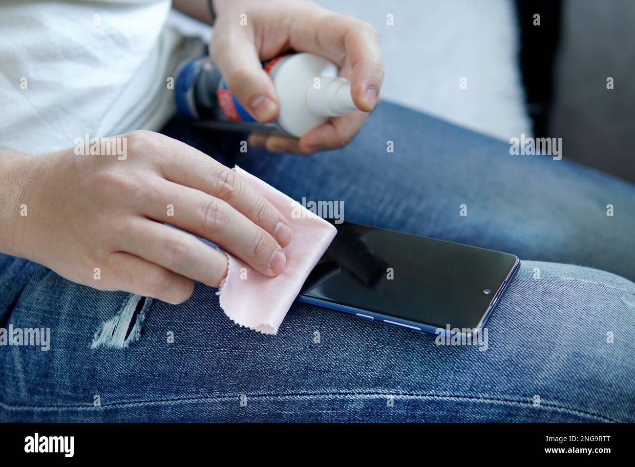 man cleaning smartphone screen with alcohol. Concept of Cleaning dirty