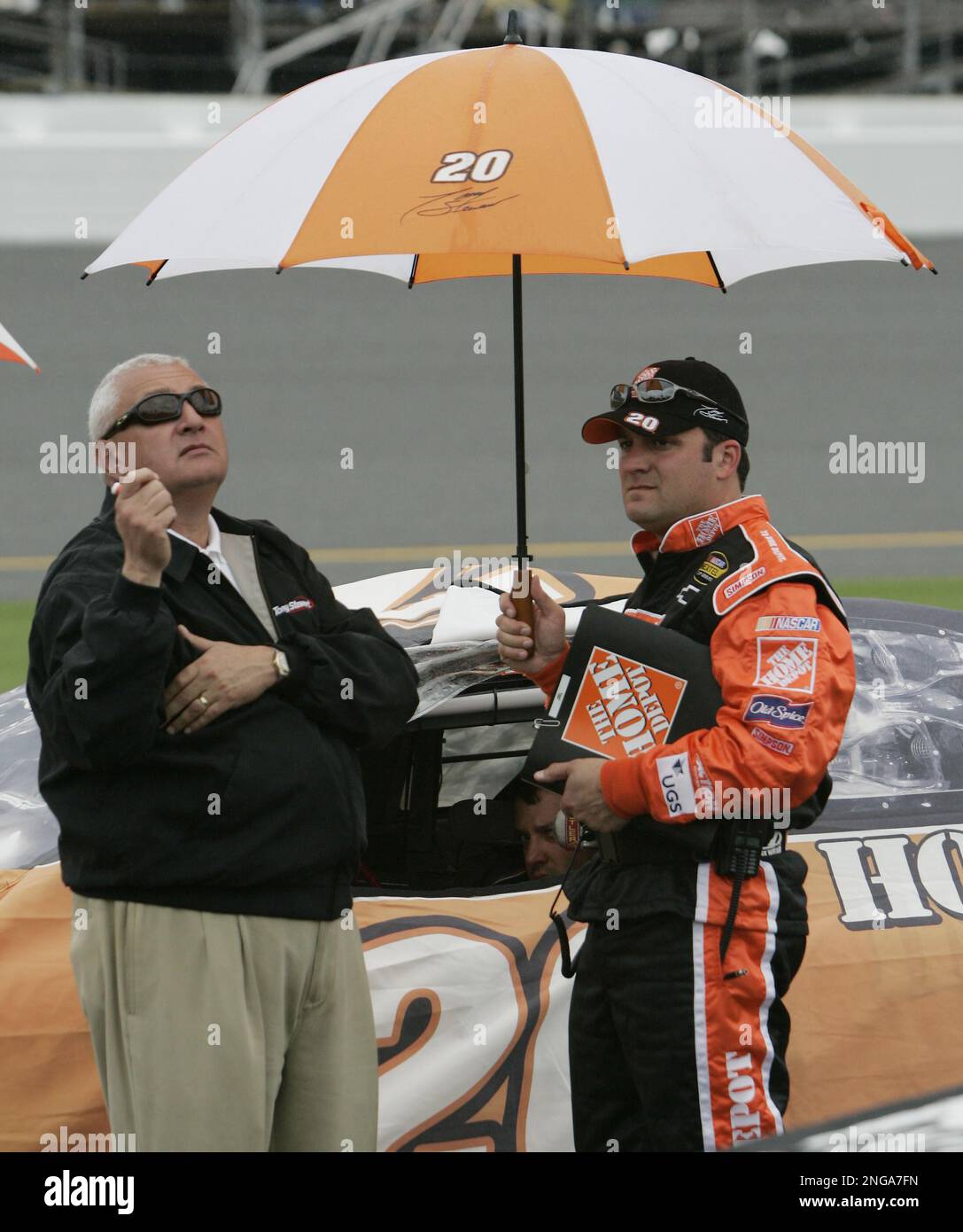 NASCAR driver Tony Stewart sits in his car as his manager