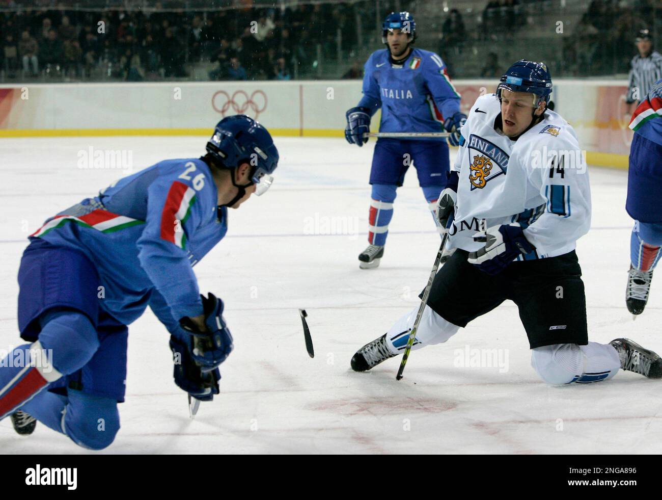 Finlands Niklas Hagman (14), of the NHLs Dallas Stars, breaks his stick shooting as Italys Armin Helfer (26) defends during the second period of a 2006 Winter Olympics mens ice hockey match