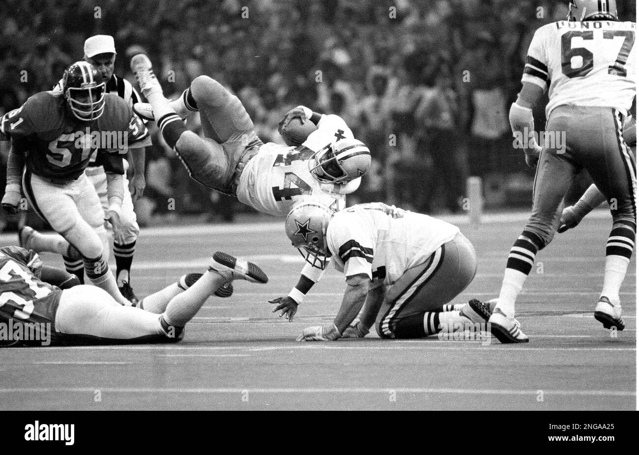 Dallas running back Robert Newhouse (44) is tripped up after a
