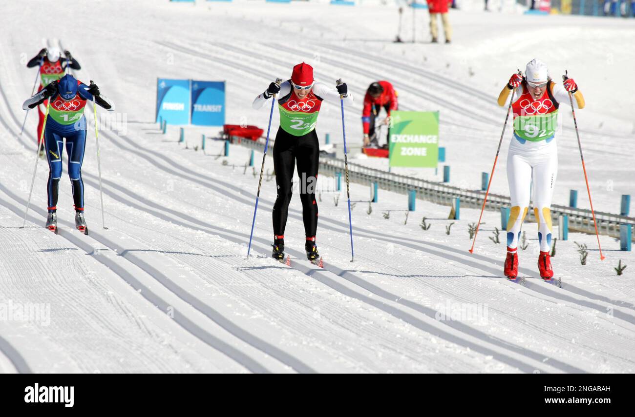 Sweden's Lina Andersson, right, pulls away to win the gold medal ahead of  silver medal winner Beckie Scott from Canada, center, and Virpi Kuitunen  from Finland, left, during the Women's Cross Country