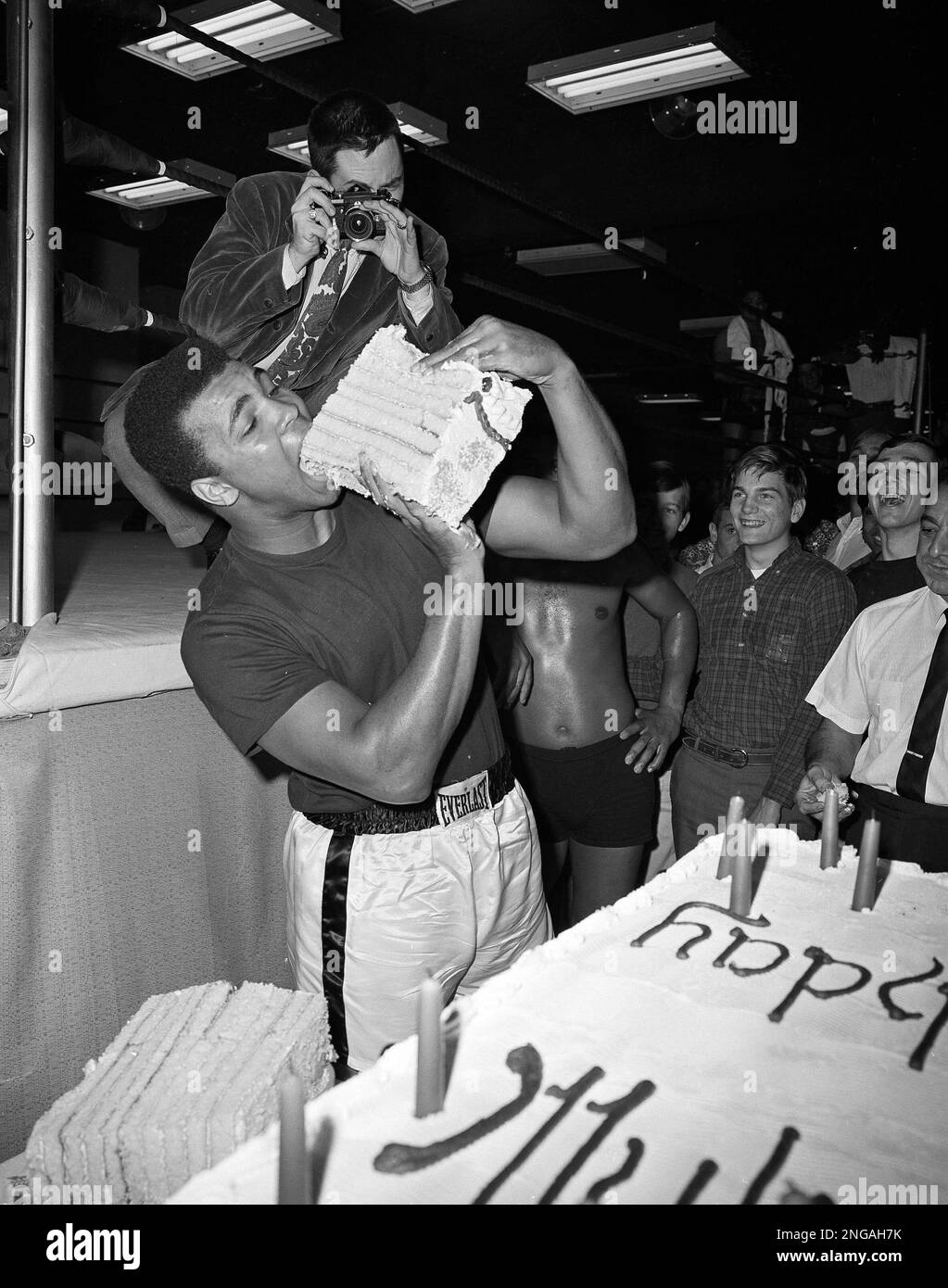 Muhammad Ali is seen taking a big bite from a huge piece of cake baked for  his 25th birthday today, Jan. 17, 1967. The cake, weighing 578 1/2 pounds,  was presented to