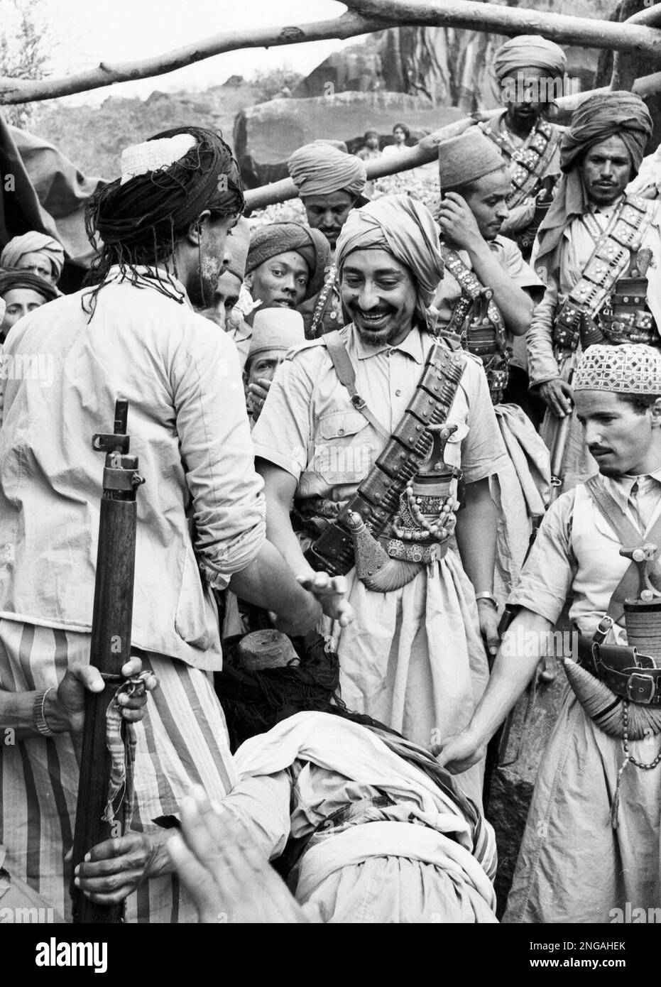 Imam Mohammed El Bada, centre, deposed ruler of Yemen, chats with some