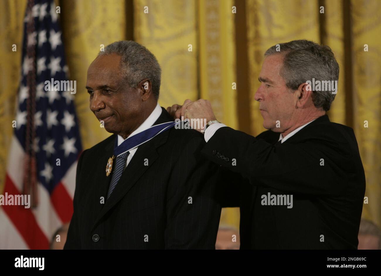 Hall of Famer Frank Robinson (L) presents Detroit Tigers Miguel