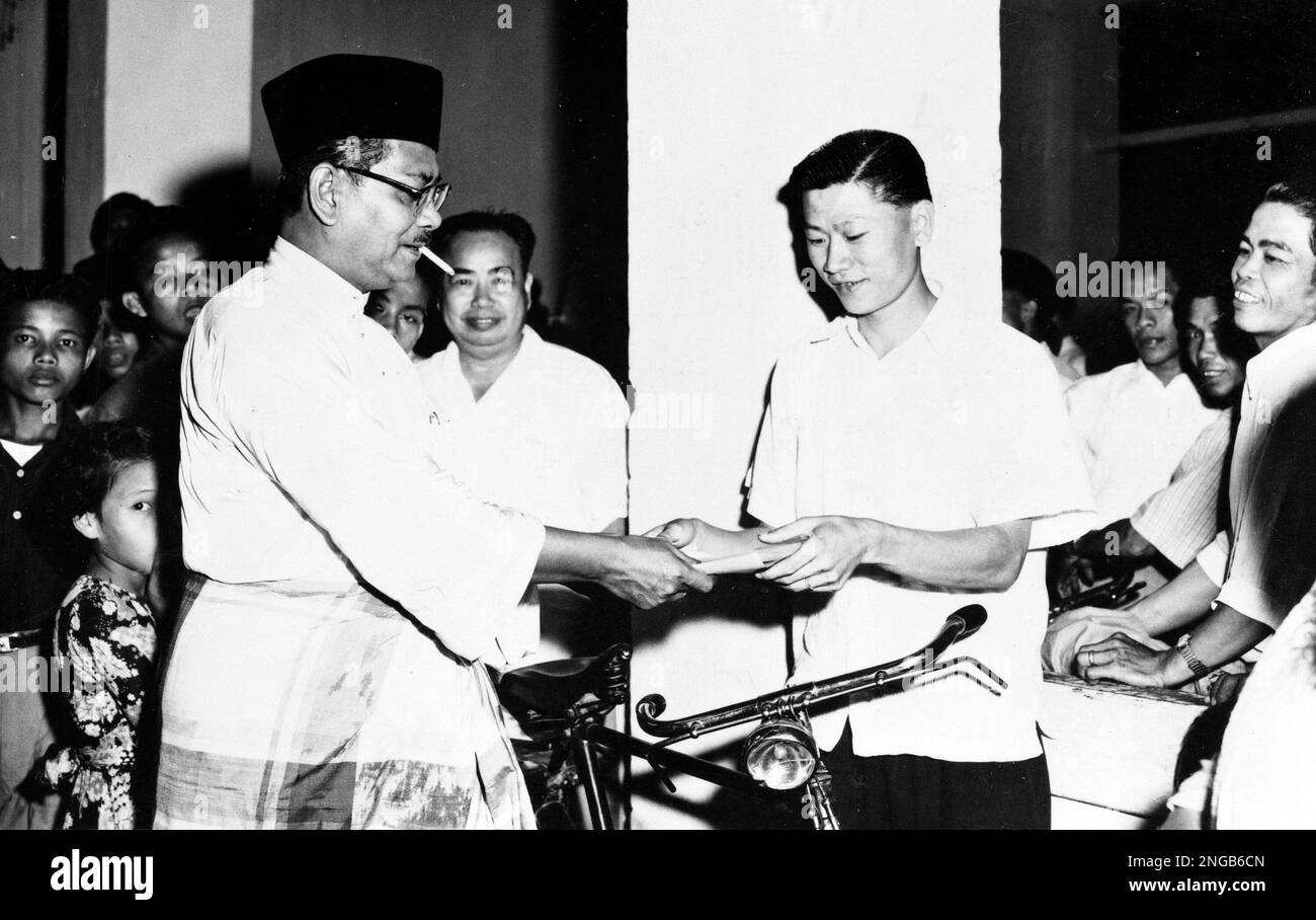 Malaysia's Chief Minister Tunku Abdul Rahman hands out leaflets ...
