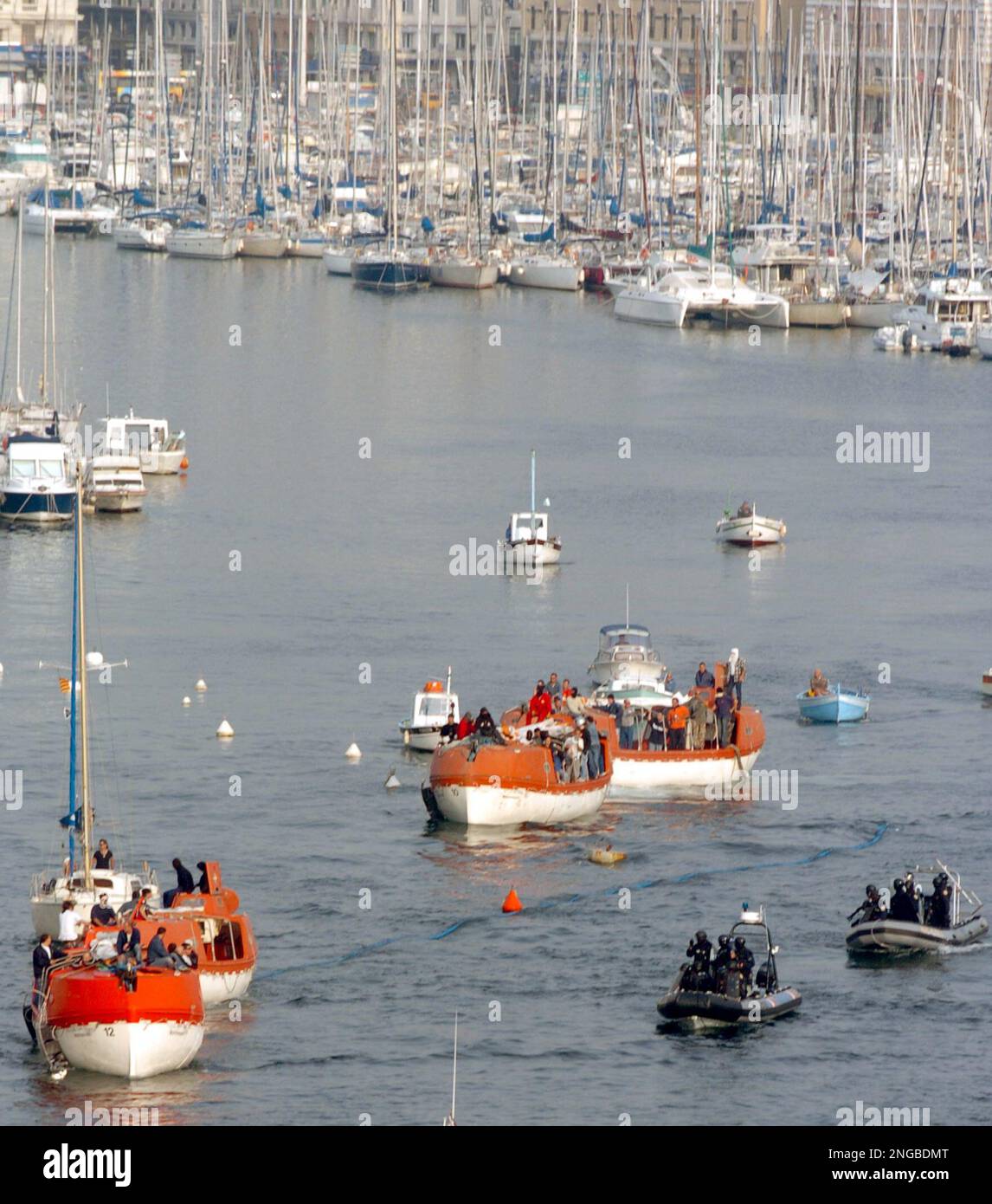 Policemen aboard two dinghies, right, escort protesters aboard ferry  evacuation boats out of the old port of Marseille, southern France,  Tuesday, Sept. 27, 2005, after police fired tear gas to disperse the