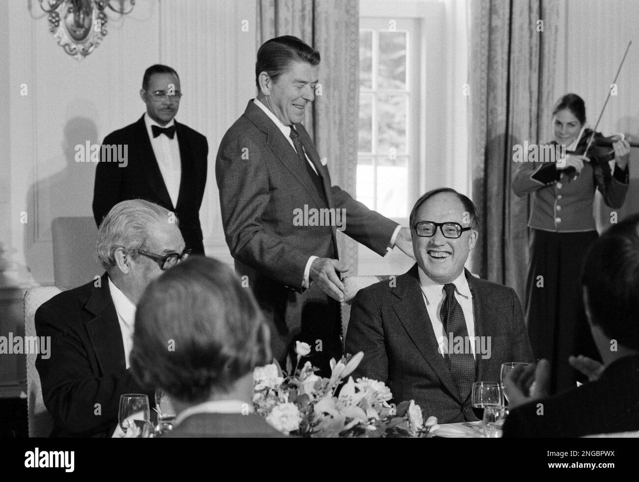 Supreme Court Justice William Rehnquist celebrates his 58th birthday as President Reagan looks on, during a luncheon in the state dining room of the White House, Oct. 2, 1982. (AP Photo/Barry Thumma) Stock Photo