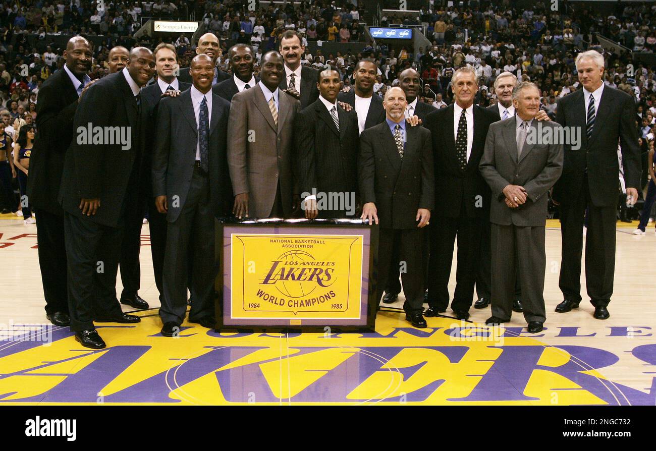 Members of the 1985 Los Angeles Lakers pose for a photo in a