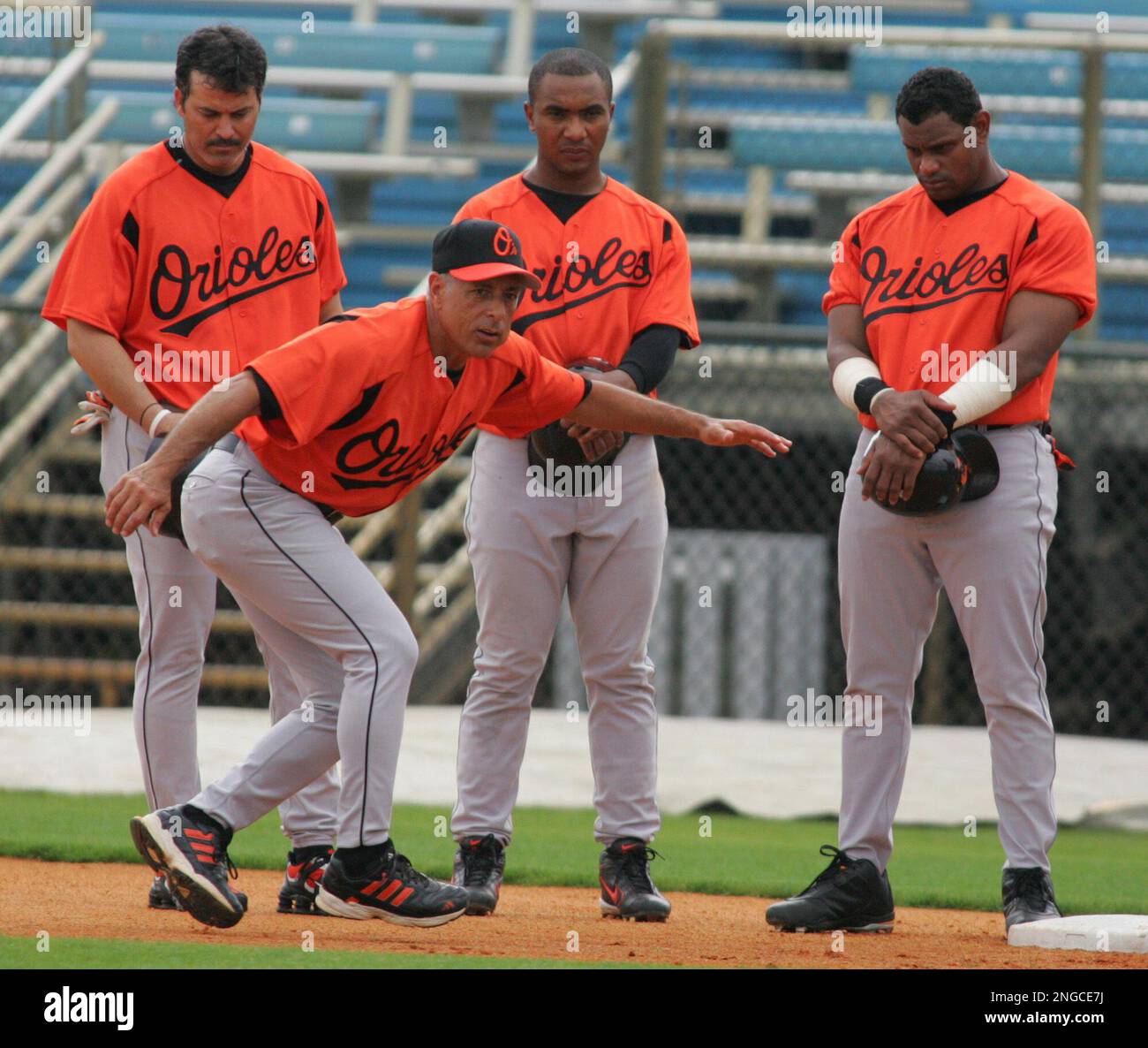 Baltimore Orioles' Rafael Palmeiro, rear left, Melvin Mora, center, and