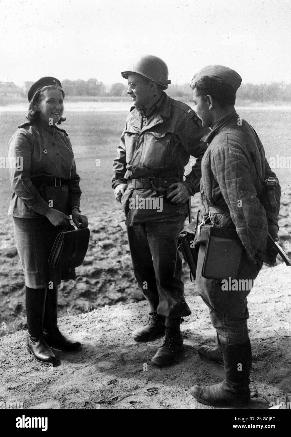 A lieutenant of the 1st U.S. Army, centre, talks to a Russian girl and