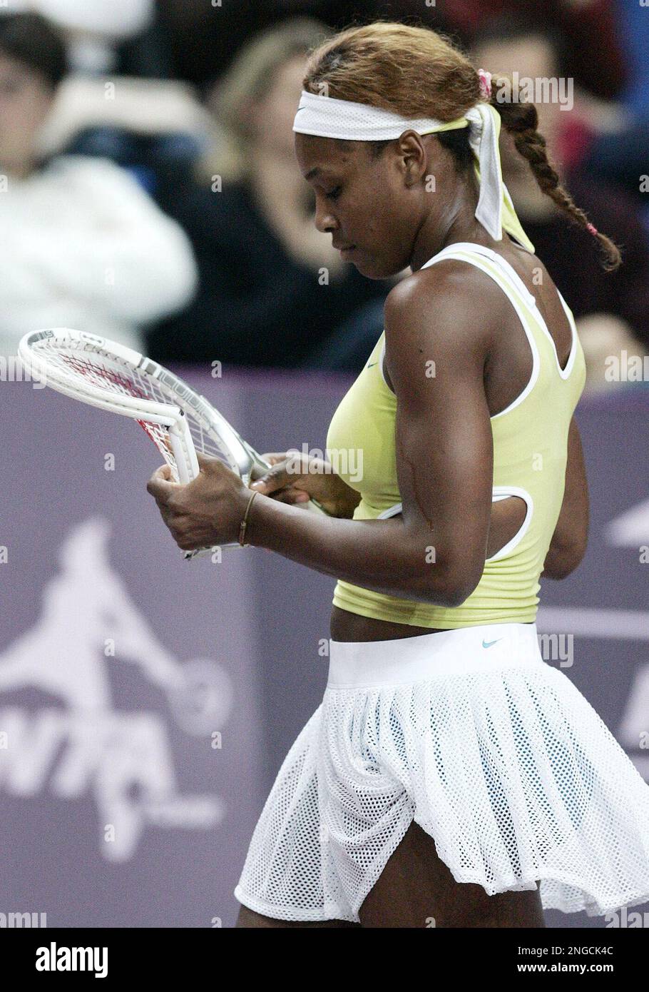 Serena Williams of the U.S. looks at her broken racket after she ...