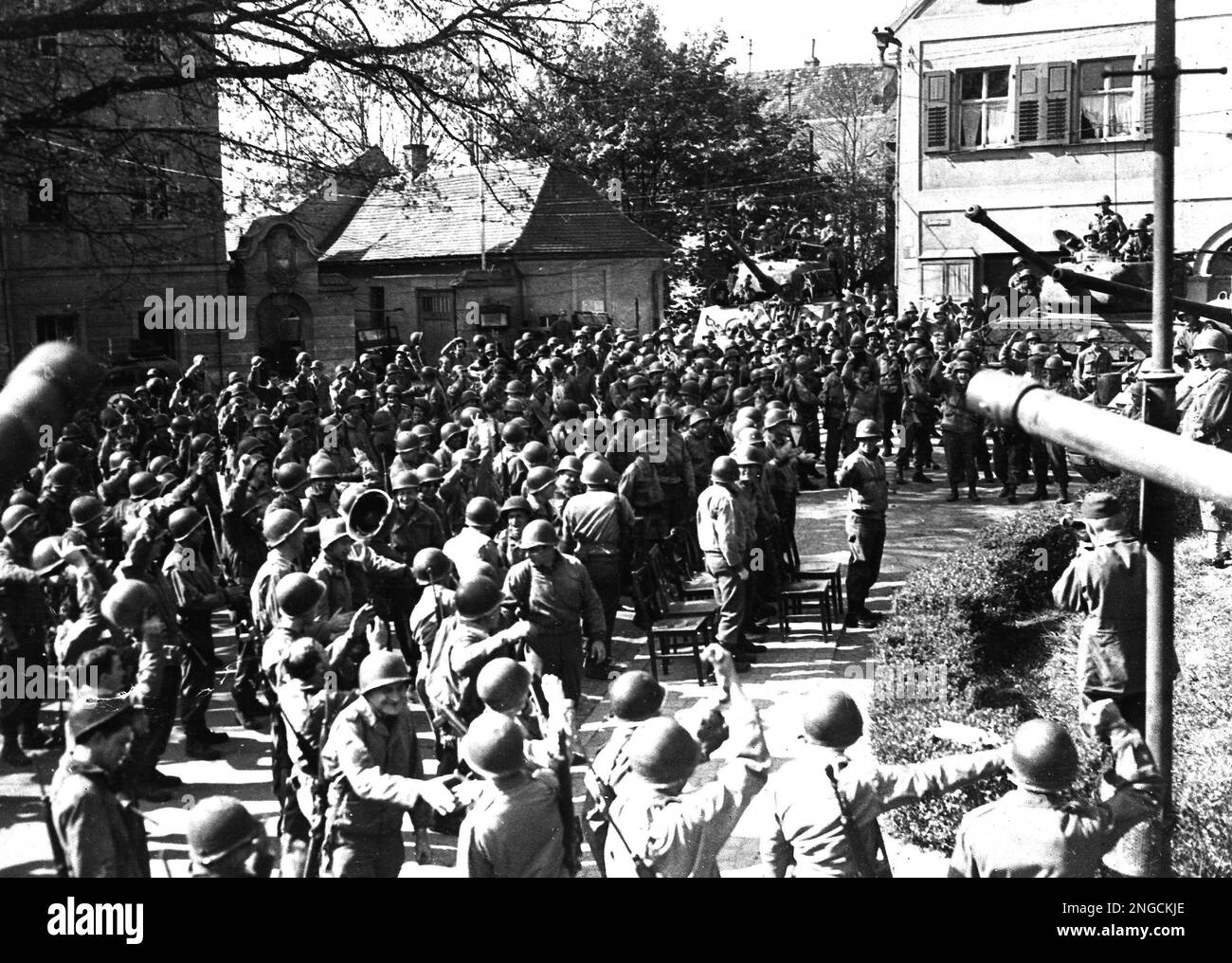 Soldiers of the 9th Armoured Division, 1st U.S. Army, slap one another