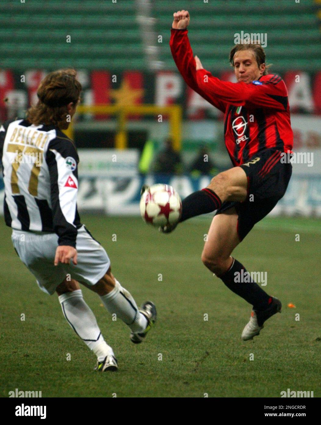 AC Milan midfielder Massimo Ambrosini, right, and Udinese defender Manuel  Belleri compete for the ball during their Italian cup quarterfinal, first  leg, soccer match at the San Siro stadium in Milan, Italy,, image size:1052x1390