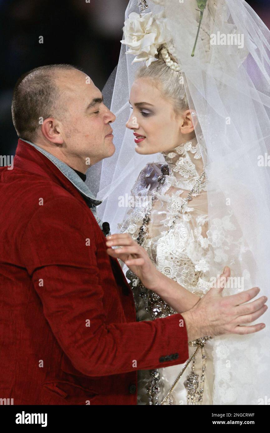 French fashion designer Christian Lacroix, left, kisses a model wearing