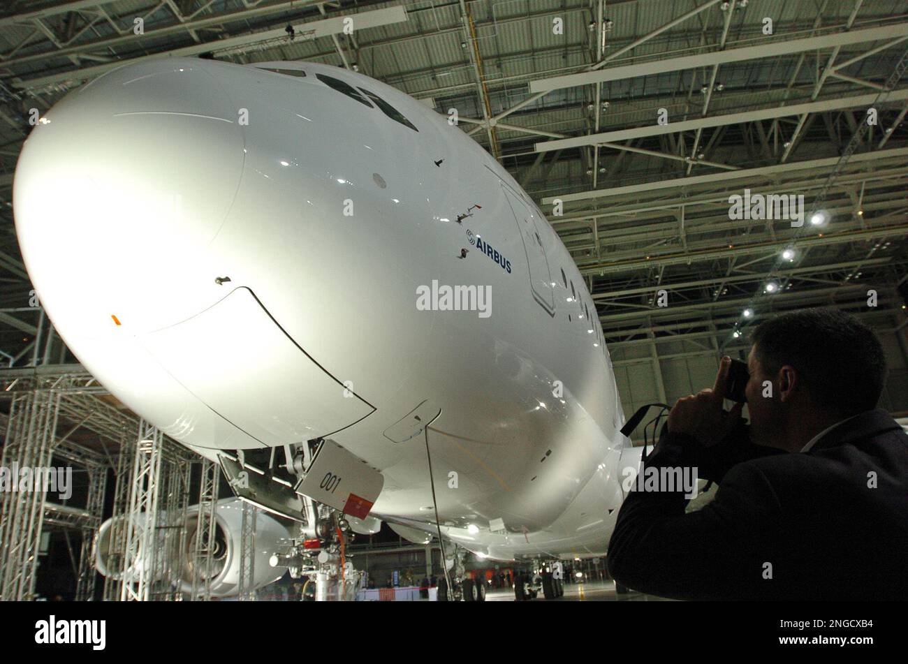 A man takes pictures of the new Airbus A380 after its unveiling