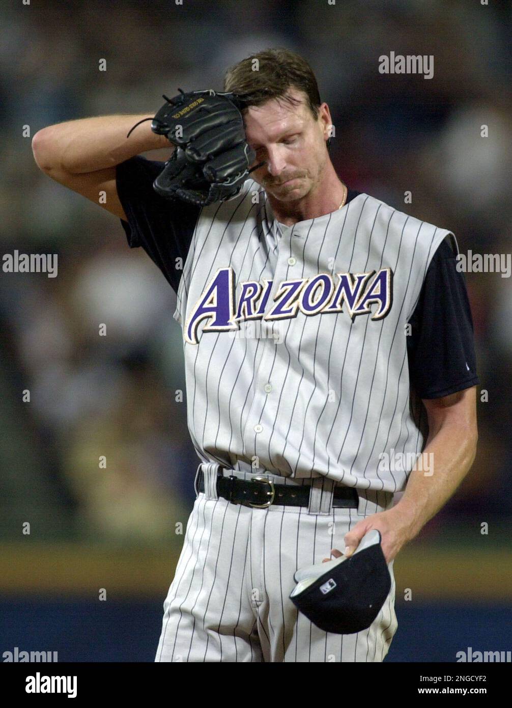 Arizona Diamondbacks starting pitcher Randy Johnson wipes his face after  allowing a three-run homer to Atlanta Braves' Vinny Castilla in the third  inning in Atlanta, Friday, Aug. 15, 2003. (AP Photo/John Bazemore