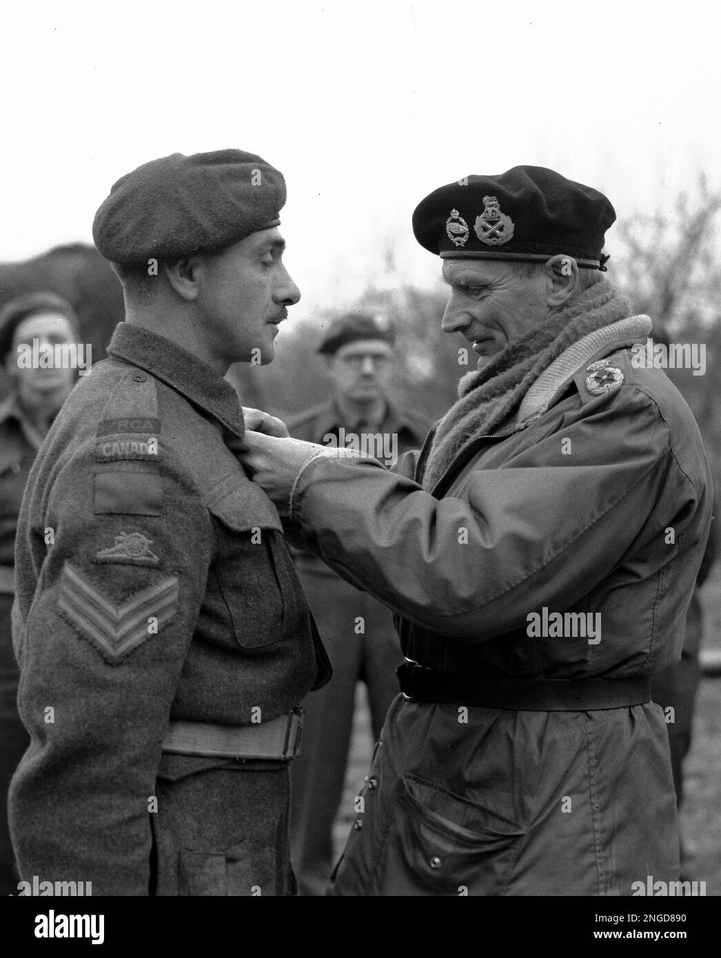 Field Marshal Bernard Montgomery pins the Military Medal on the tunic