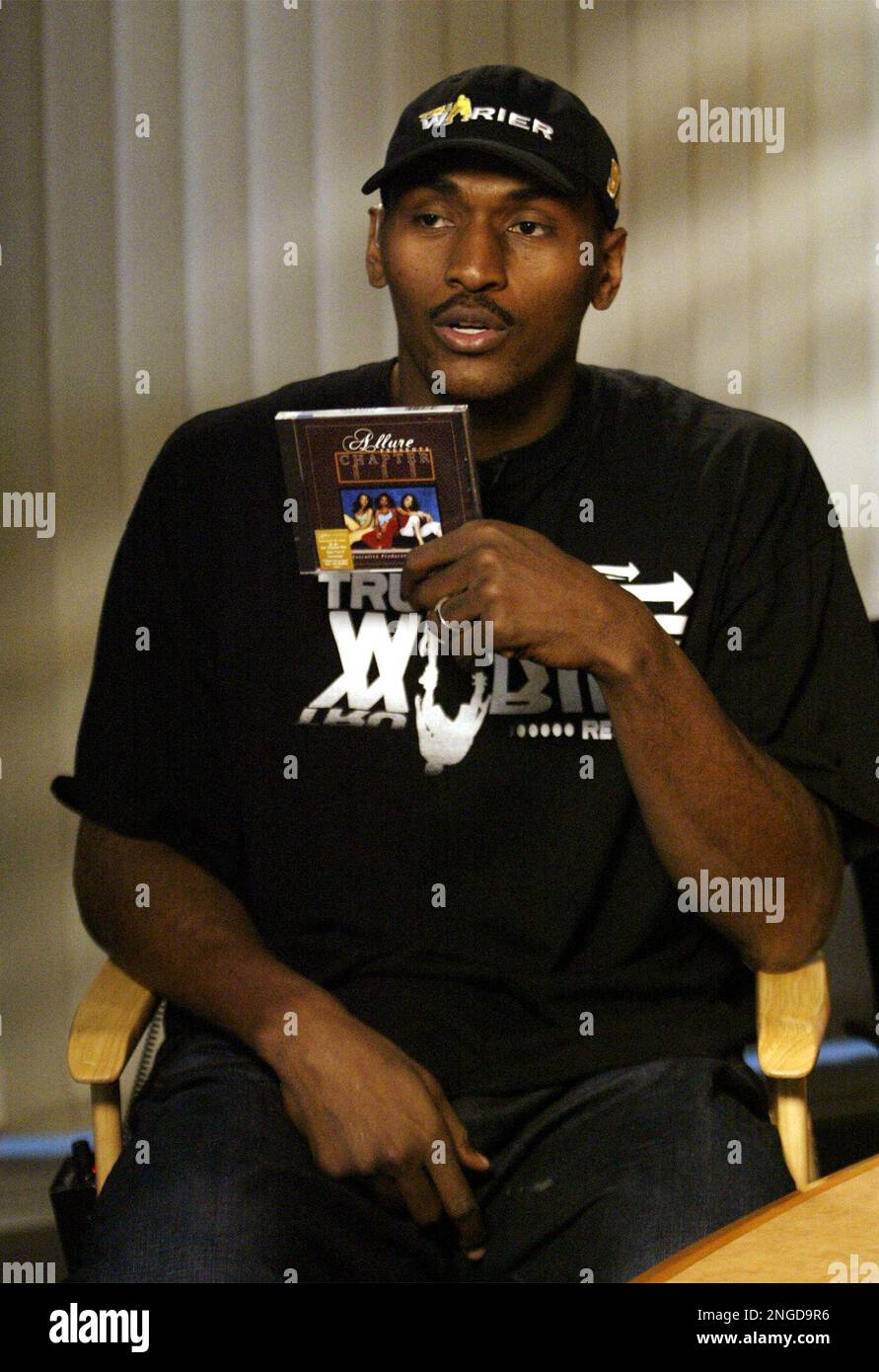 Suspended Indiana Pacers player Ron Artest holds up a copy of a CD he is promoting during a MSNBC interview at an Indianapolis radio station Tuesday, Nov. 23, 2004. Artest was suspended for the rest of the season for fighting with a fan at the end of a game with the Detroit Pistons last Friday. (AP Photo/Tom Strattman) Stock Photo