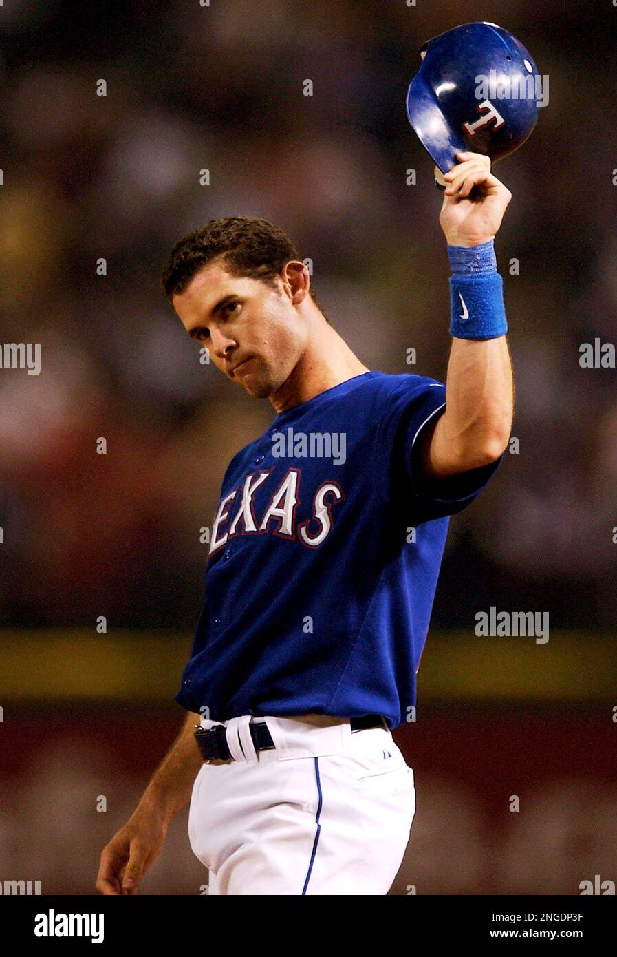 Texas Rangers' Michael Young tips his batting cap to the cheers of fans  following his 210th hit of the season off of Anaheim Angels' Jarrod  Washburn, tying the most hits ever by