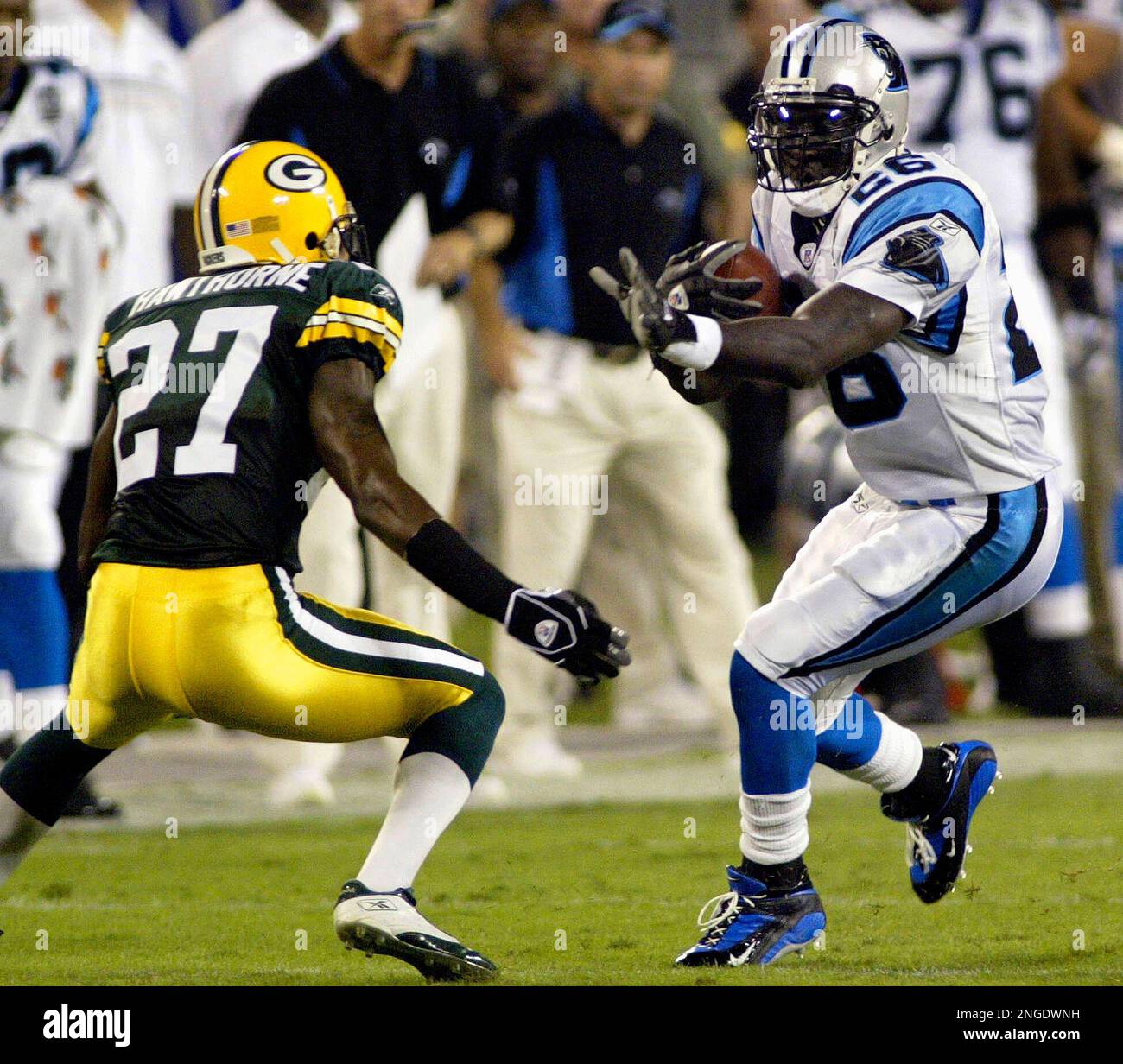 Carolina Panthers' DeShaun Foster (26) tries to run past Green Bay Packers'  Michael Hawthorne (27) during the first quarter in Charlotte, N.C., Monday  Sept. 13, 2004. (AP Photo/Rick Havner Stock Photo - Alamy