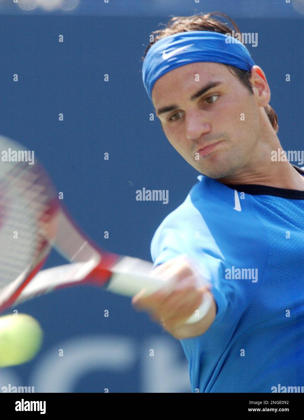 Roger Federer, of Switzerland, returns a shot to Fabrice Santoro, of