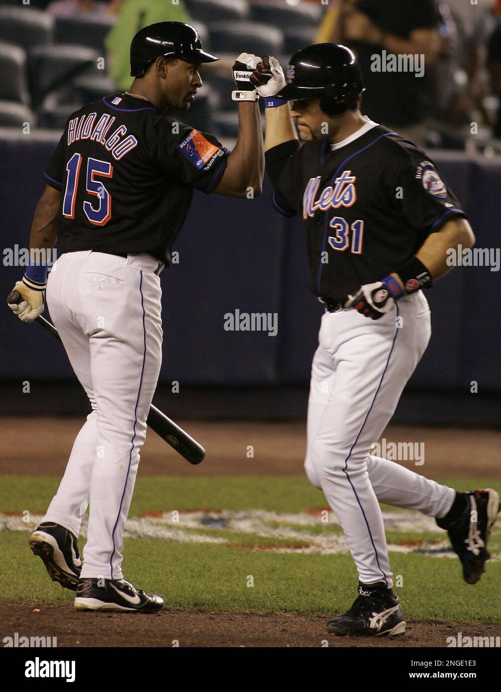 New York Mets' Mike Piazza is congratulated by Richard Hidalgo after  hitting a solo home run against the Florida Marlins during the third  inning, Monday, Aug. 30, 2004 at Shea Stadium in