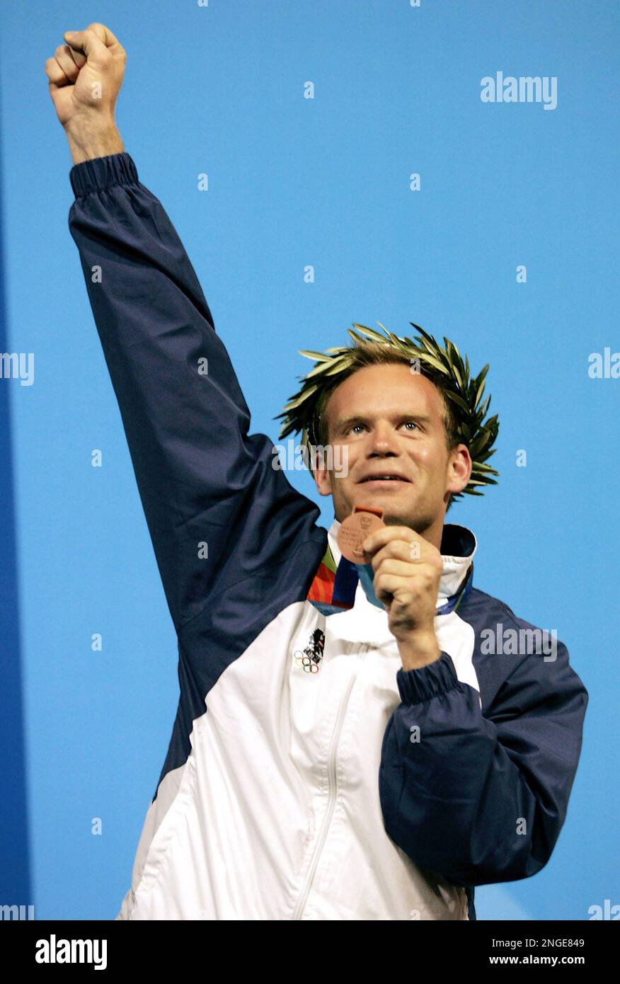 Austria's Christian Planer celebrates his third place finish on the podium  after the men's 50m rifle 3 position finals Sunday, Aug. 22, 2004, at the  2004 Summer Olympics in Athens. China's Jia