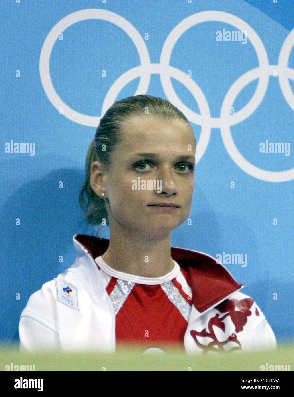 Svetlana Khorkina of Russia sits on the bench prior to the vault during