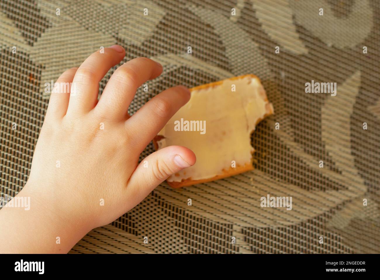 children's hand and cookies with butter on the table Stock Photo