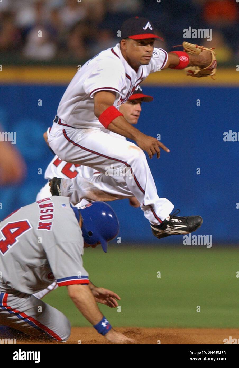 Atlanta Braves shortstop Rafael Furcal follows through on a throw to first  base for a double play in the ninth after tagging out New York Mets' Cliff  Floyd as second baseman Marcus