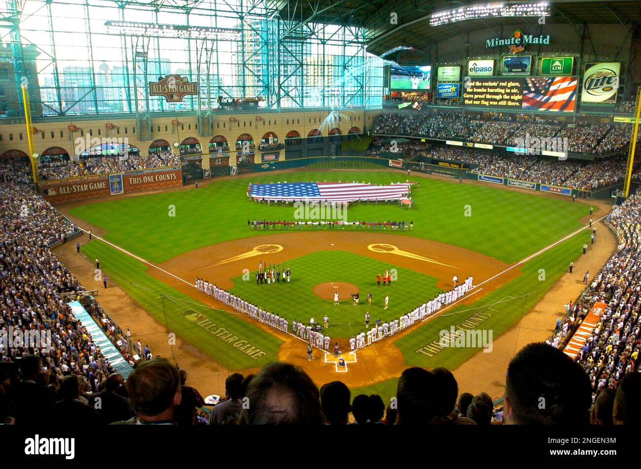 FILE - In this April 5, 1999 file photo, The Atlanta Braves, right, and the  Philadelphia Phillies line the base paths as a giant American flag is  stretched across the outfield while