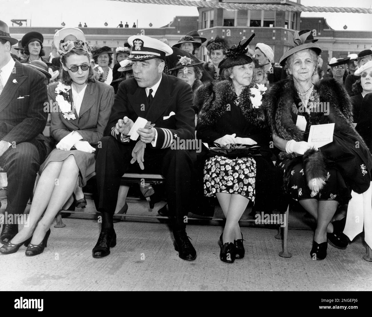 Seated in the first row of the grandstands, Commander Vincent Astor