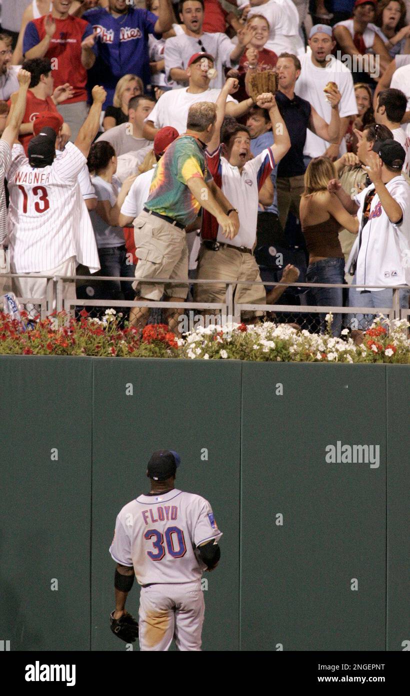 New York Mets' Cliff Floyd watches as fans cheer and bobble a game-winning  walk-off home run ball hit by Philadelphia Phillies' Bobby Abreu in the  ninth inning, Thursday, July 8, 2004, in