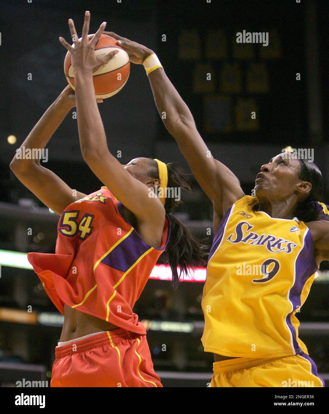 Los Angeles Sparks' Lisa Leslie, right, blocks a shot by Phoenix