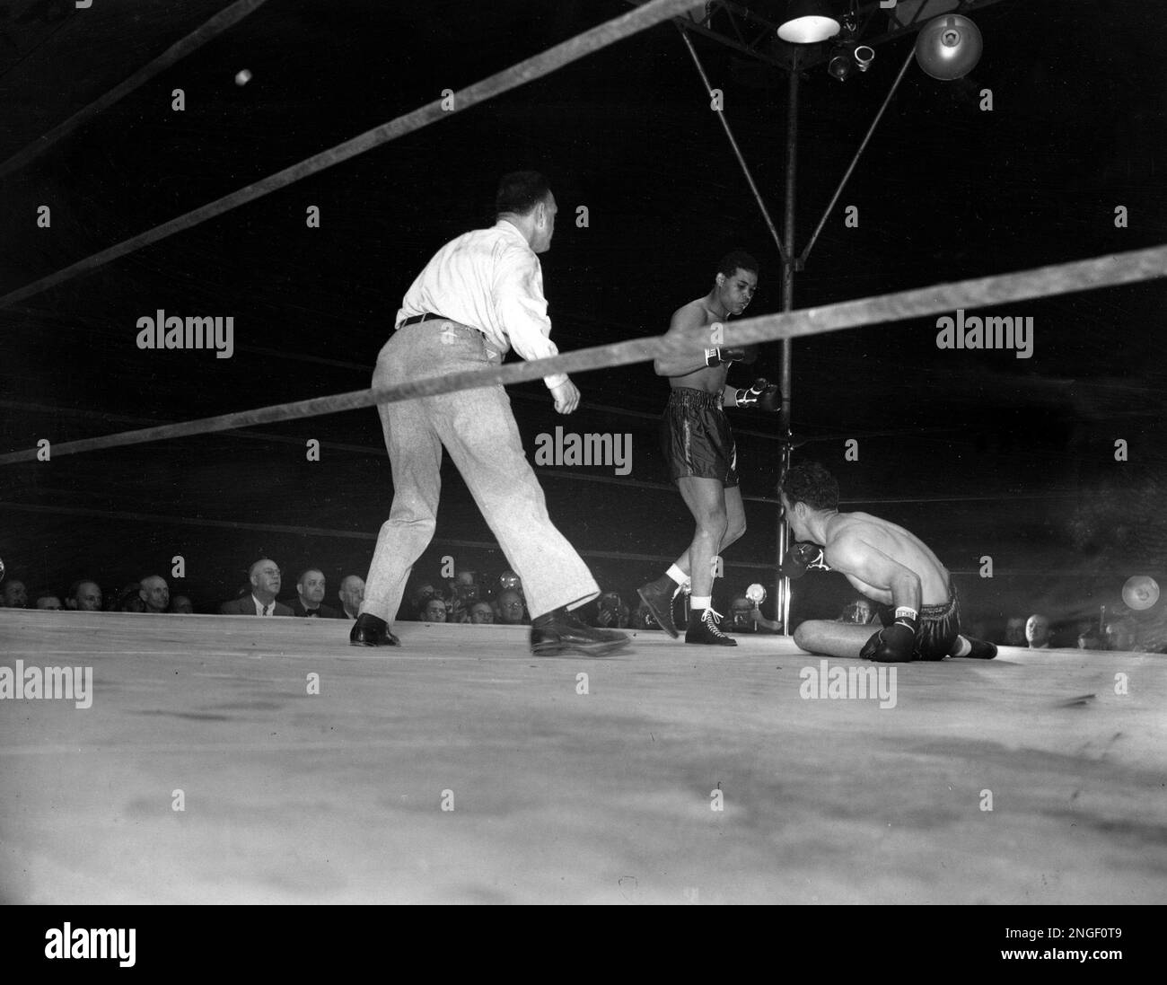 World heavyweight champion Joe Louis stands over challenger Billy Conn ...