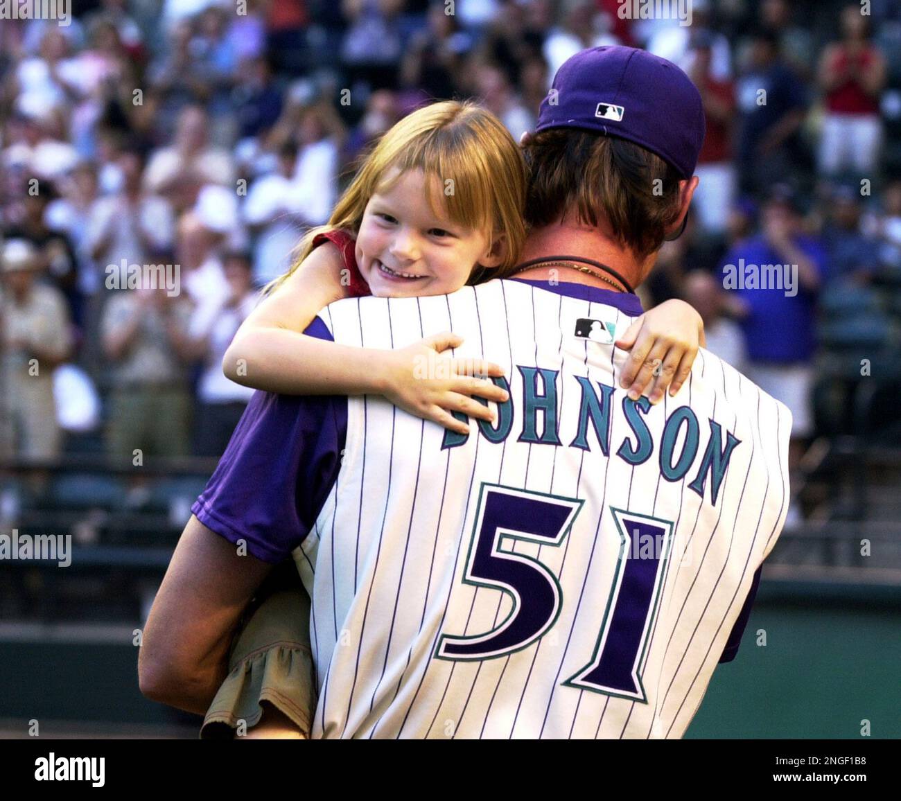 Arizona Diamondbacks pitcher Randy Johnson, right, hugs his daughter, Lexi,  left, during pregame ceremonies honoring Johnson's perfect game against the  Atlanta Barves on May 18, prior to the game against the San