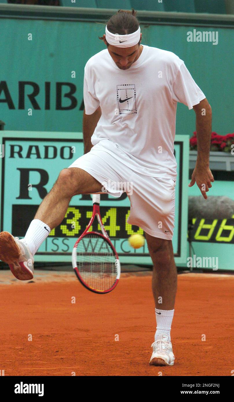 Switzerland's top-seeded Roger Federer returns the ball between his legs  during a training session for the French Open tennis tournament at Roland  Garros stadium in Paris, Friday May 21, 2004. The French