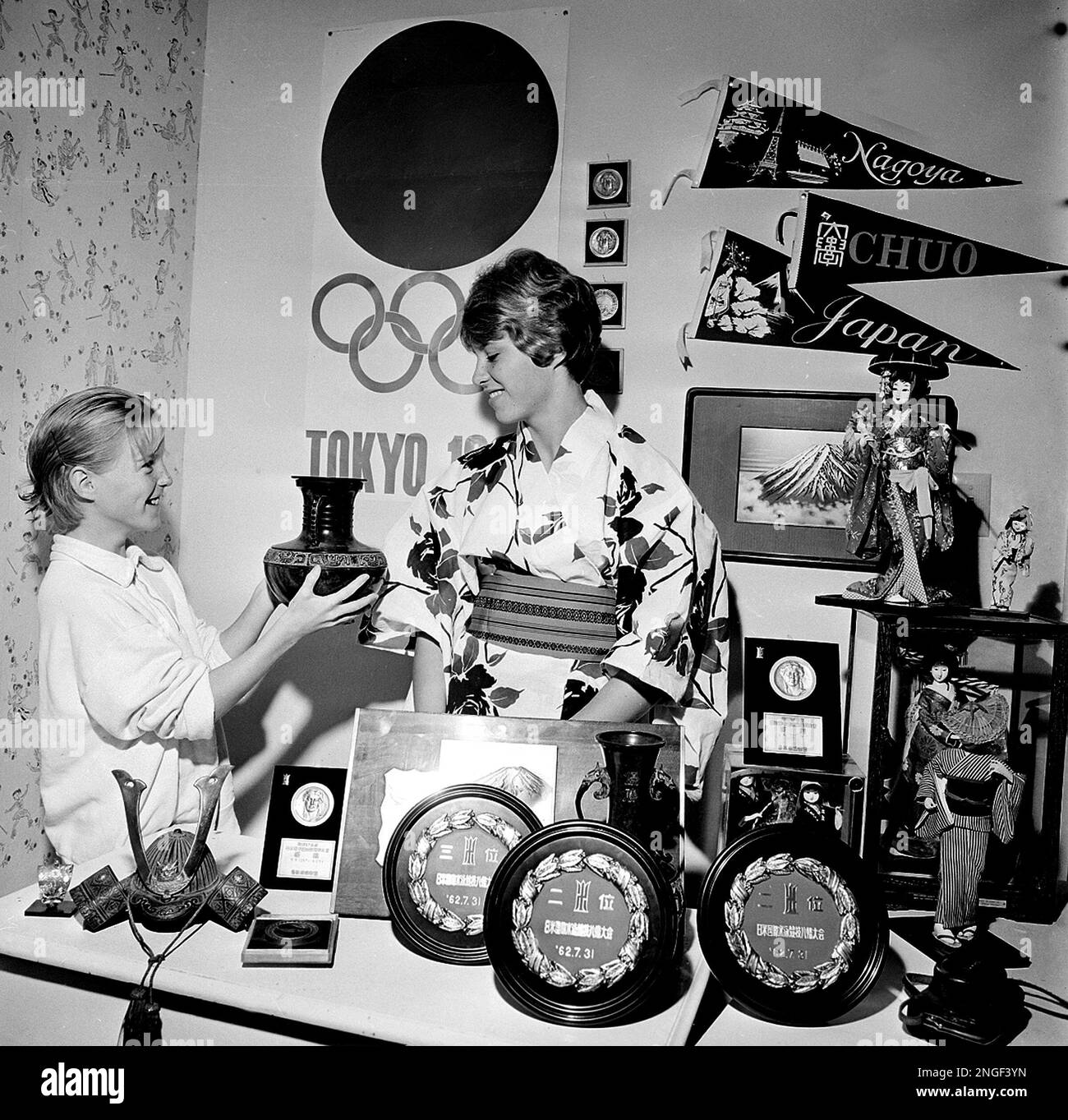 Champion swimmer Donna de Varona wears a kimono as she shows her sister, Jo  Anne, some of her trophies and momentos of two tours of Japan at their home  in Santa Clara